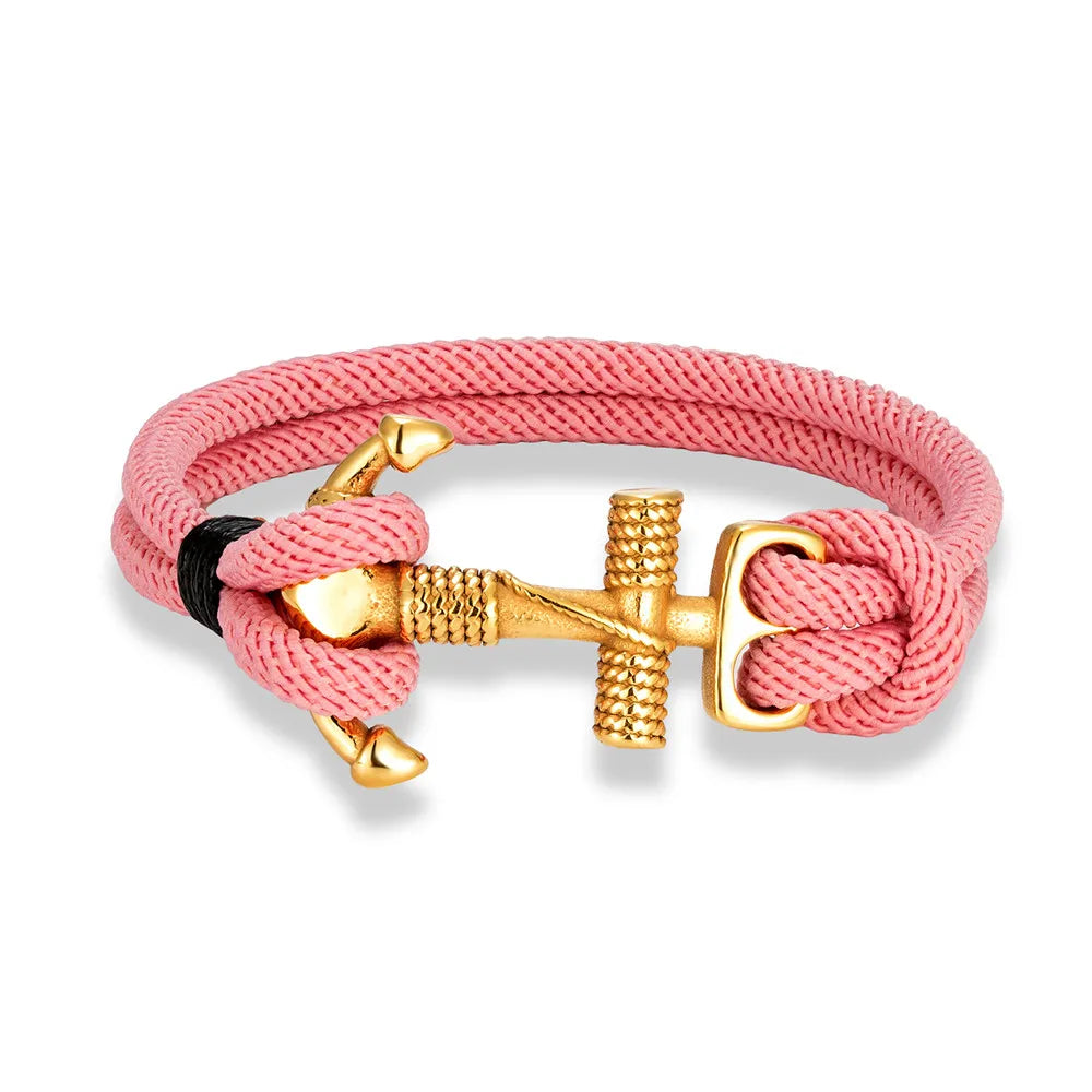 A gold plated stainless steel anchor charm bracelet with a red double strand nautical surfer rope.