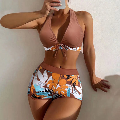 Brown bikini with floral patterned bottom against a neutral background
