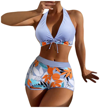 Woman wearing a light blueHigh Waist Plant Print Bikini Set with floral patterned bottom on a white background