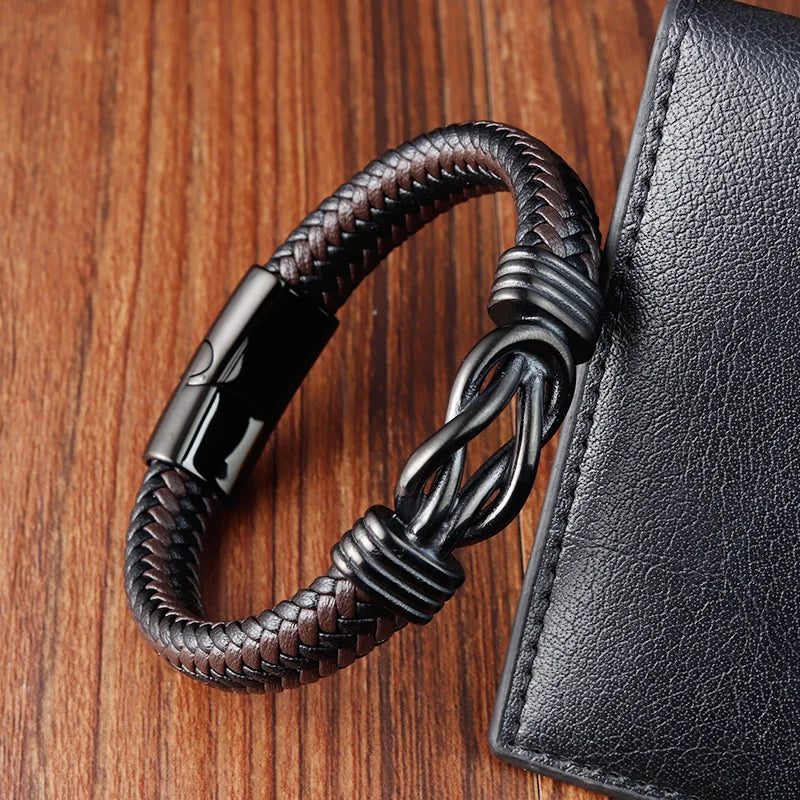 A black brown leather bracelet adorned with a black metal clasp, highlighting a sophisticated and minimalist aesthetic.