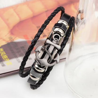 A stylish black leather bracelet featuring a silver clasp and an anchor charm, perfect for nautical-themed accessories.