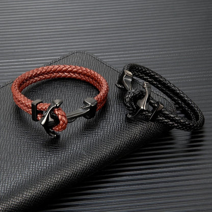 Two stylish leather bracelets: one features an anchor, while the other is a sleek black leather design.