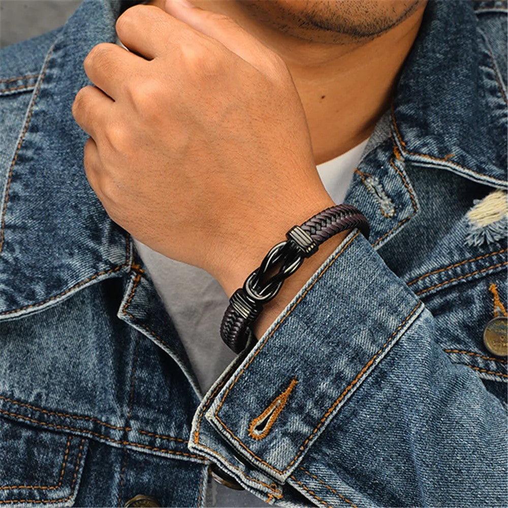 A man in a denim jacket accessorized with a stylish bracelet, exuding a casual yet fashionable vibe.