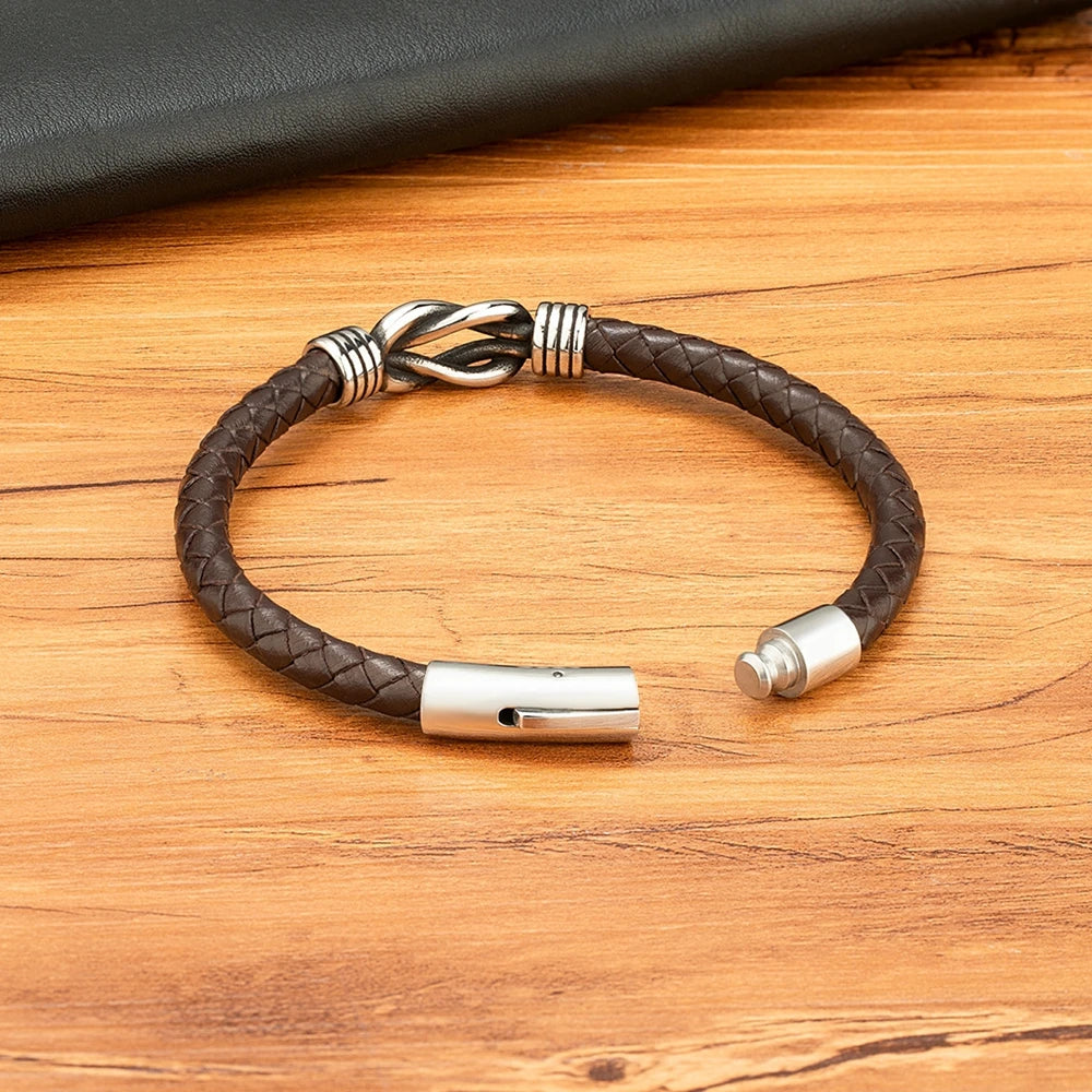 A stylish leather bracelet featuring a silver clasp and a matching leather clasp for a sophisticated look.