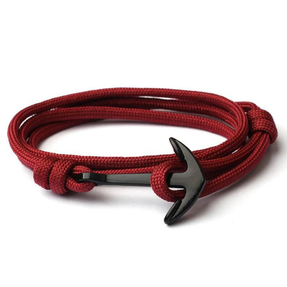 A stylish red rope bracelet featuring a silver anchor charm, perfect for nautical-themed accessories.