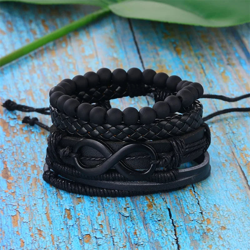 A stack of elegant black bracelets featuring a prominent infinity knot design, symbolizing endless love and connection