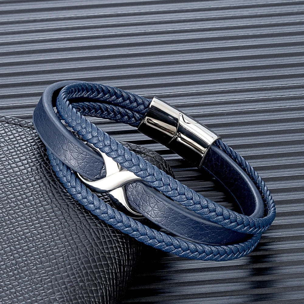 A blue leather bracelet featuring a silver clasp and a stylish leather band, showcasing elegance and craftsmanship.