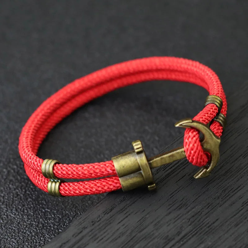 A stylish red rope bracelet featuring a silver anchor charm, perfect for nautical-themed accessories.